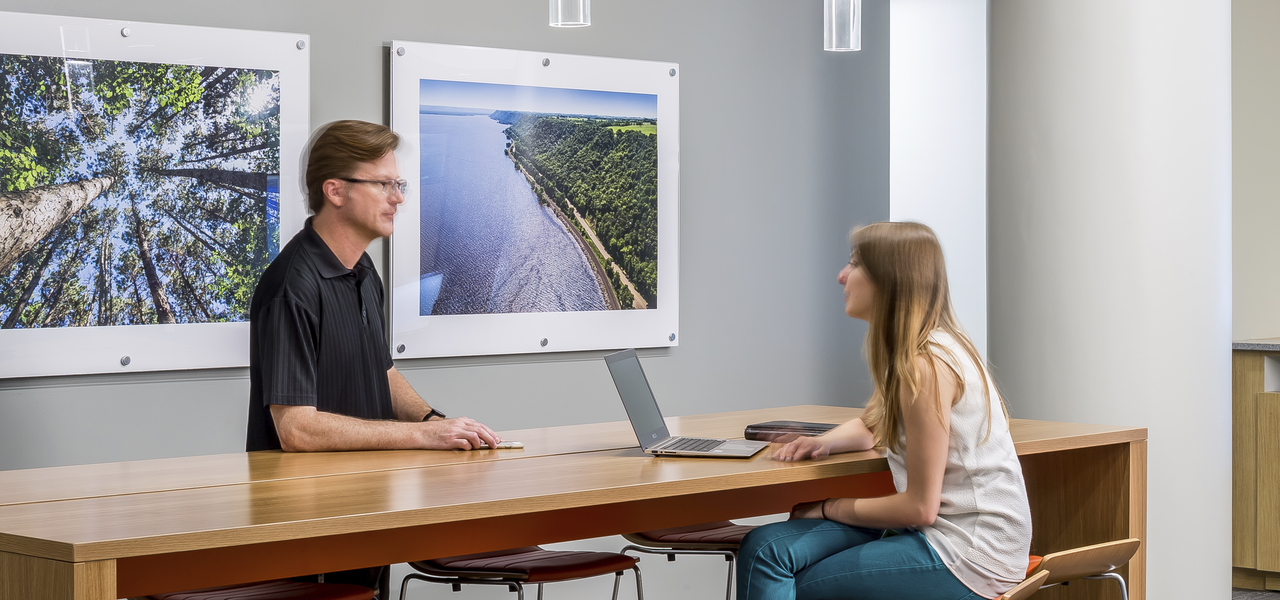 Two people work at an alternative workstation.