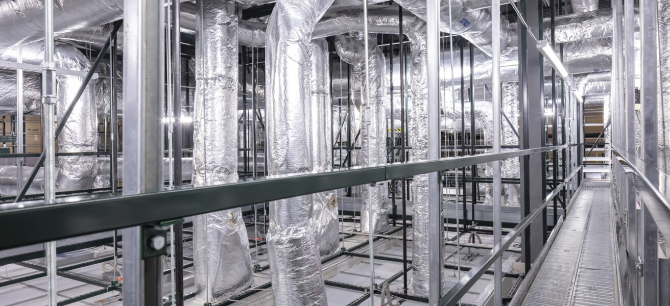 A catwalk with mechanical access above a clean production facility.