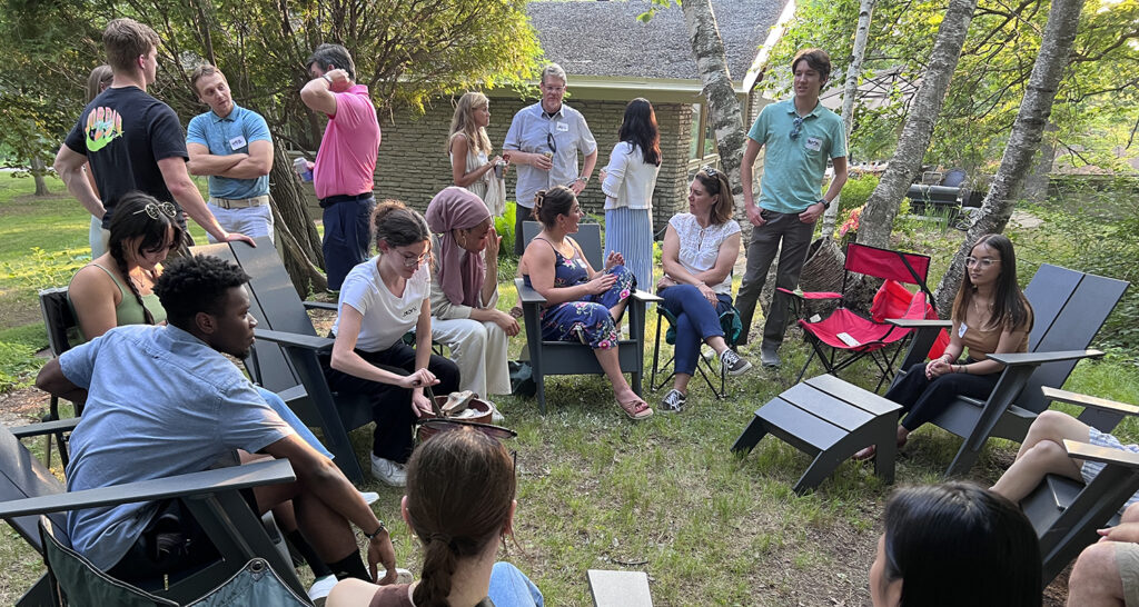 BWBR student interns sit and stand in a casual circle at CEO Stephanie McDaniel's house.