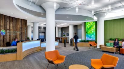 People walk through the nature-inspired, colorful MPCA reception lobby.