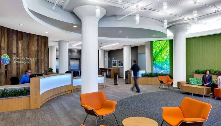 People walk through the nature-inspired, colorful MPCA reception lobby.