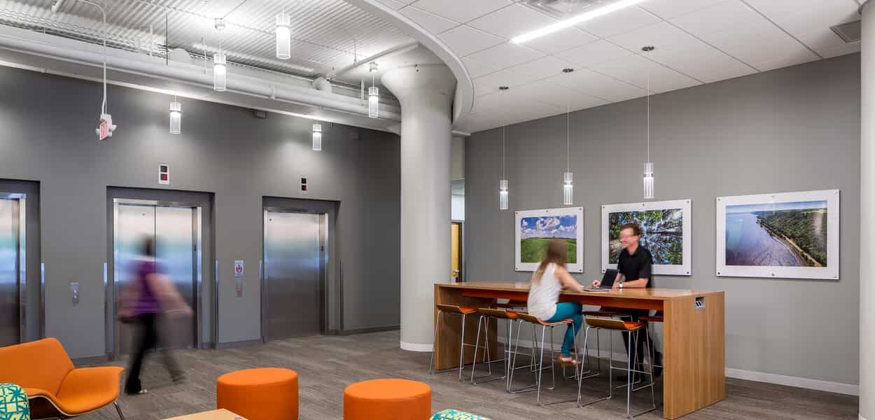 People work at a touchdown station in the MPCA elevator lobby.