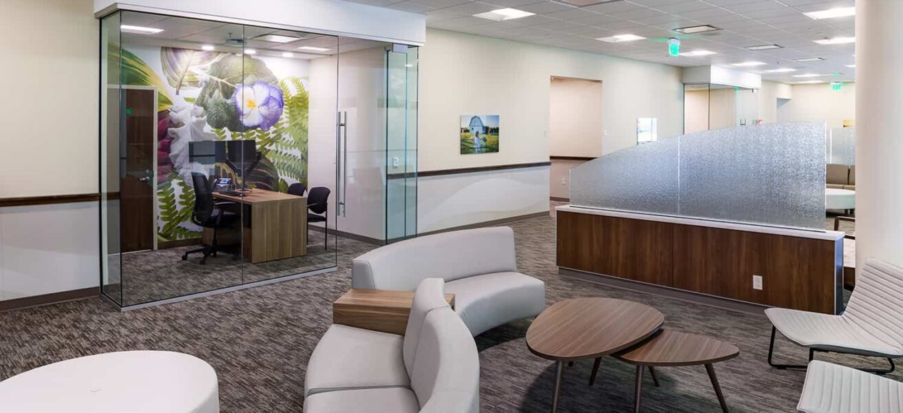 Clinic reception and waiting area with glass-walled consult room and curved seating.