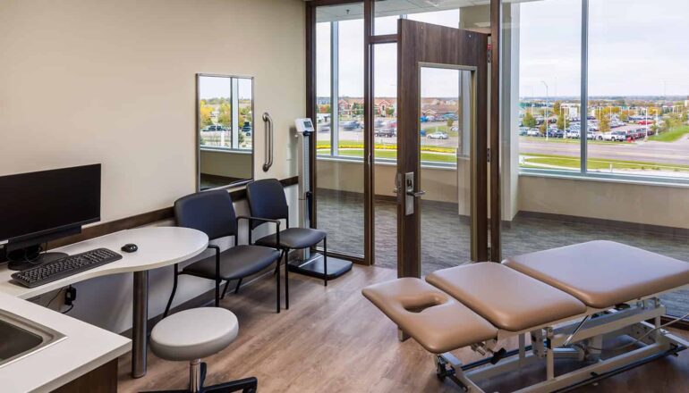 Dilation exam room with glass walls and expansive views of the surrounding landscape.