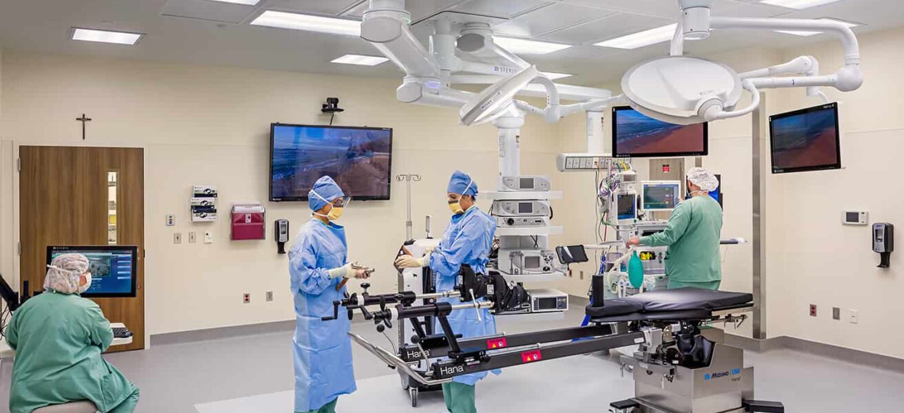 Standard operating room and four staff members operating the equipment.