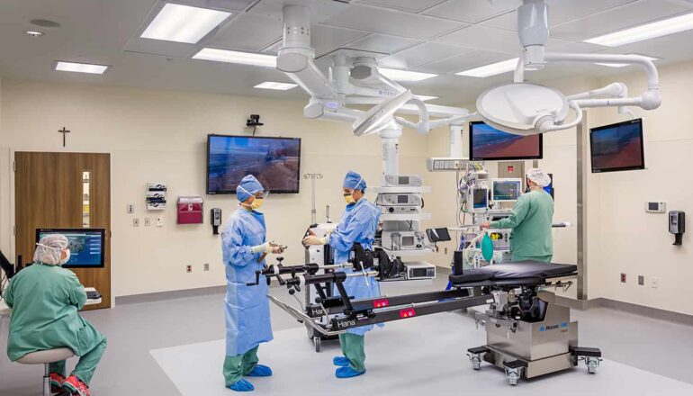 Standard operating room and four staff members operating the equipment.