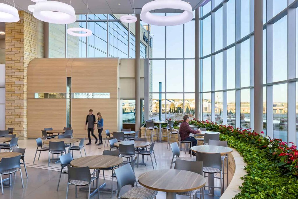 Open seating for dining and access to the meditation space, surrounded by indoor plants.