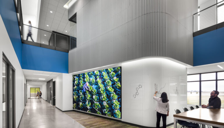 A writeable wall and large digital display enhance the employee experience.