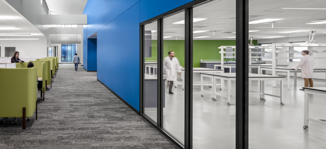 Windows from office spaces into a lab promote collaboration.