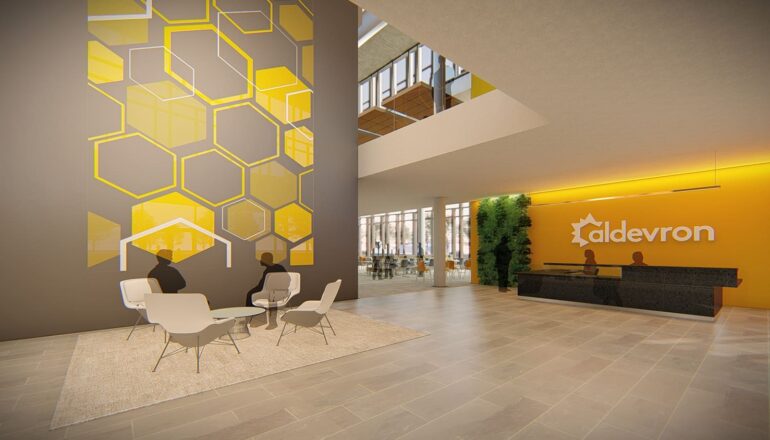 Entry into the community space, featuring branded hexagon wall graphics.