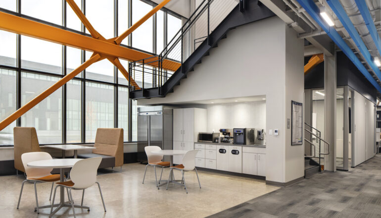 An Aldevron employee coffee bar touchdown with abundant natural light and drop-in work booths.