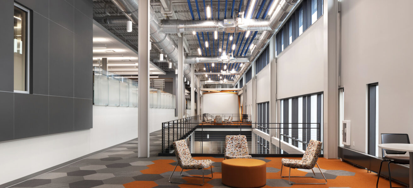 An open collaboration space looking down the long, open corridor of the Aldevron facility.