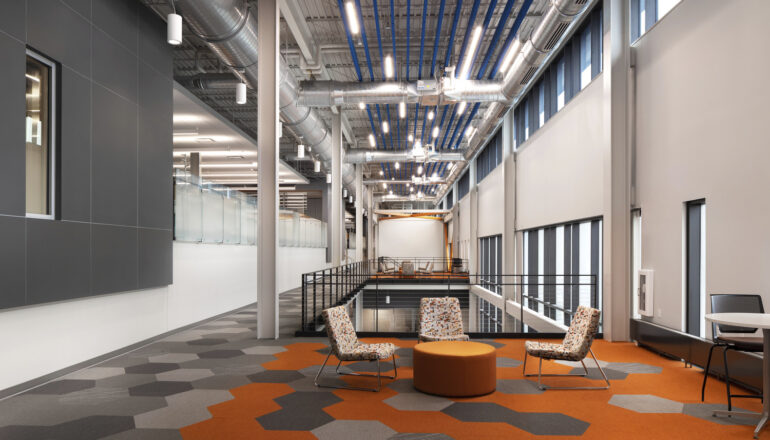 An open collaboration space looking down the long, open corridor of the Aldevron facility.