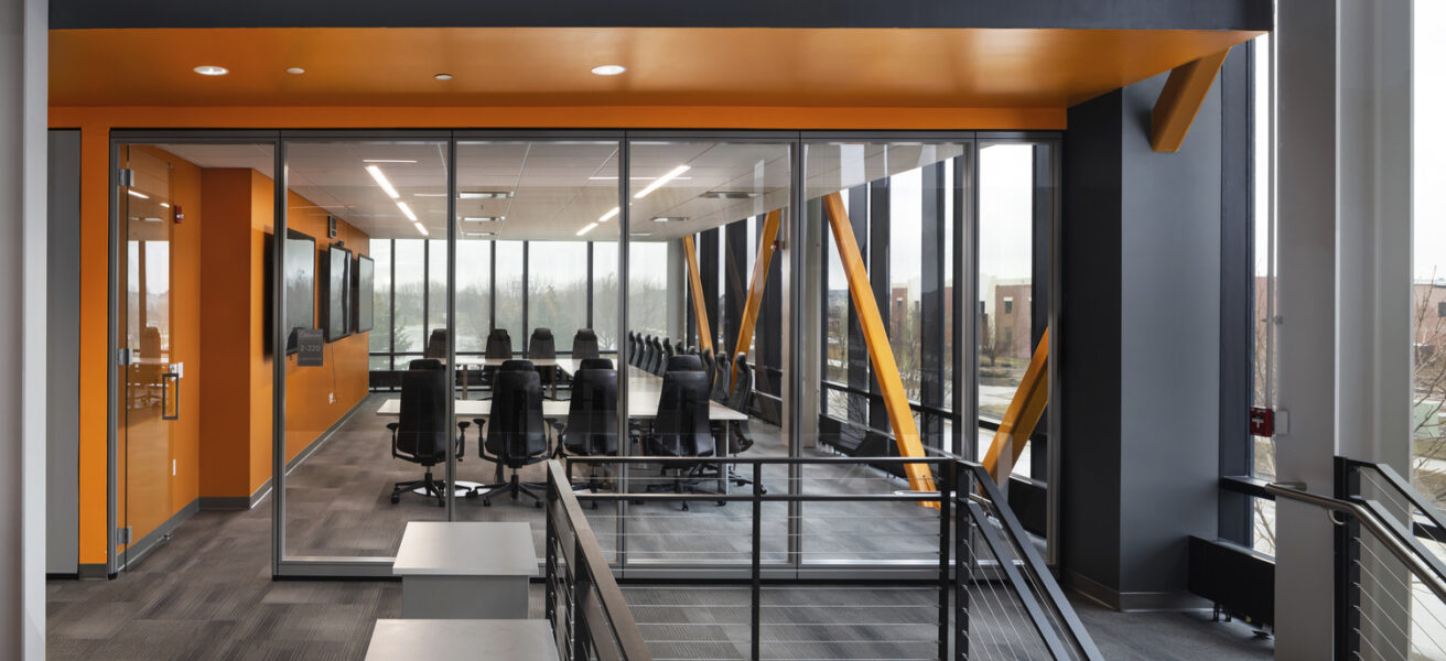 A conference room with exterior views from the corner of the Aldevron building.