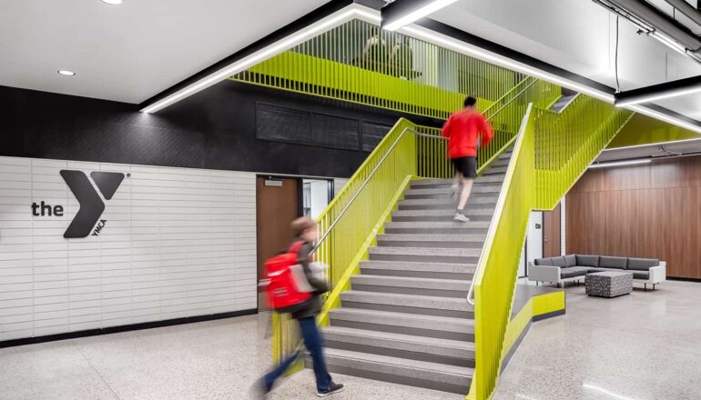 A bright green staircase invites gym-goers to take the stairs, and a seating alcove provides a quiet place for a post-workout rest.