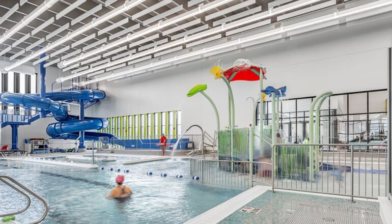 Children and adults alike enjoy the slides and pool equipment in the leisure pool area.