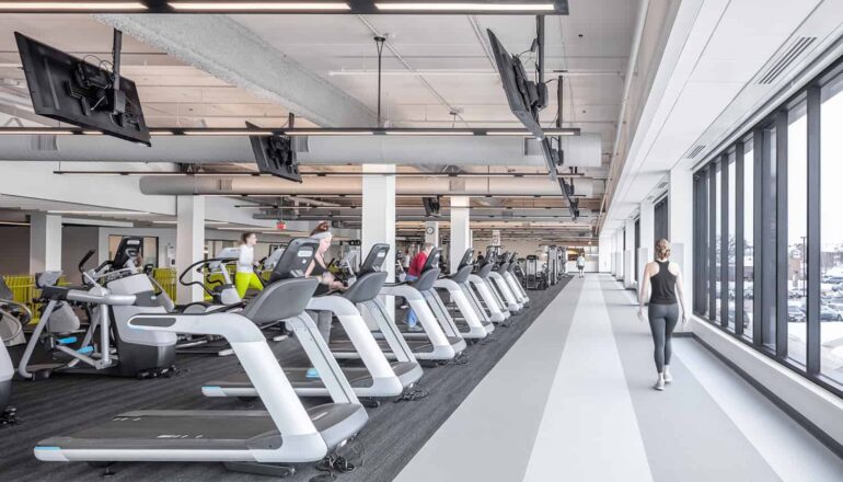 The walking track is surrounded by large windows that overlook the local community.