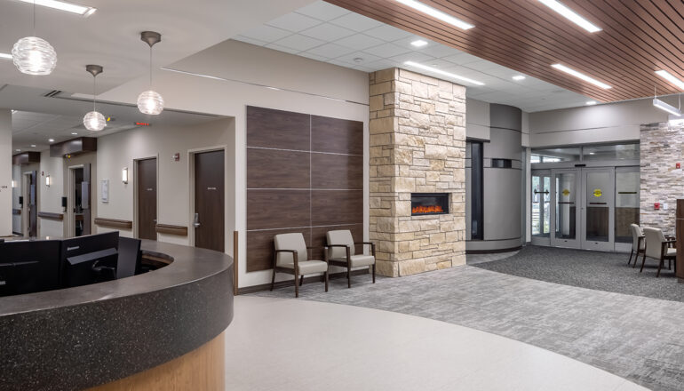 The Avera Missouri River reception and waiting with a fireplace and views to the care corridor.