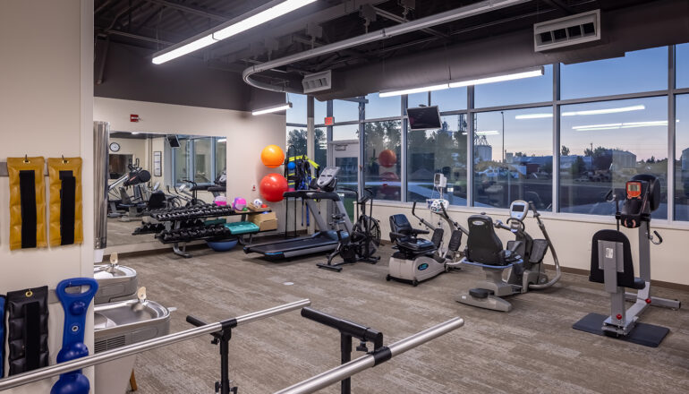 The Avera Missouri River physical therapy space at dusk with plentiful views to nature.