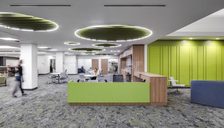 The library tutoring desk with bright green wayfinding elements.