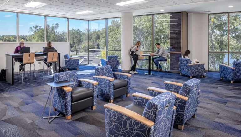 A lakeview lounge offers a quiet place for students to study together, complete with bar-height desk and comfortable armchairs.