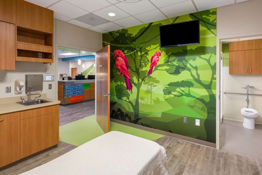 Footwall and view to the nurses station from a patient room featuring a parrot wall mural.