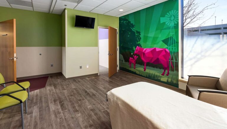 A patient room with a wall mural of cows.