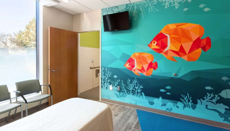 The footwall of a patient room with a wall mural of tropical fish.