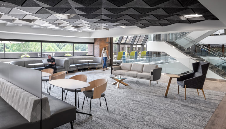 Various seating options in a CHS work cafe, and gray toned acoustical panels on the ceiling.