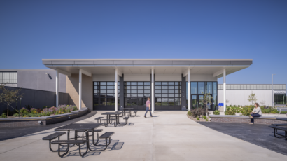 Head on shot of the front patio with outdoor student gathering spaces at the CVTC TEC.