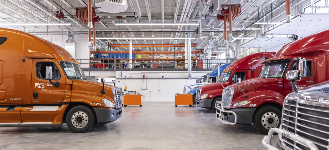 Semi trucks and tool storage in one of the education bays at CVTC.