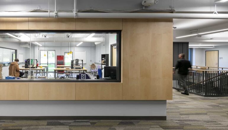 View from corridor into the Engineering maker space through an interior window.