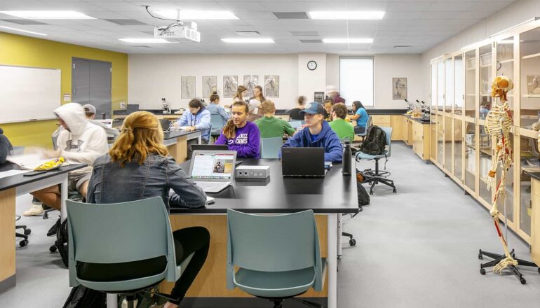 Students learning in an anatomy lab with wood frame casework.