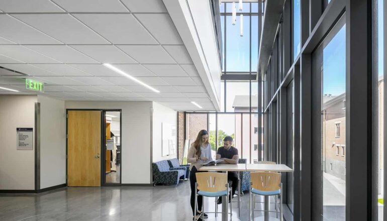 An open study area located in a classroom corridor, with two-story windows.