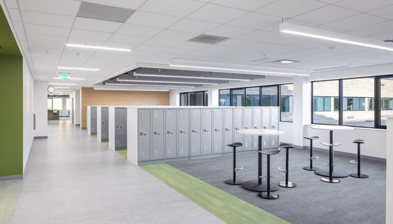 A green themed locker bay features drop-in study tables for Cotter Schools students