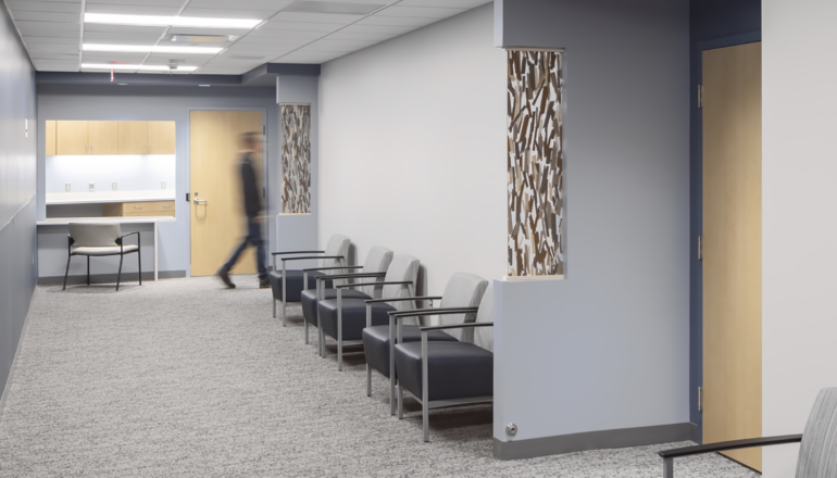 A person walks through a waiting corridor in the Crete Area facility.