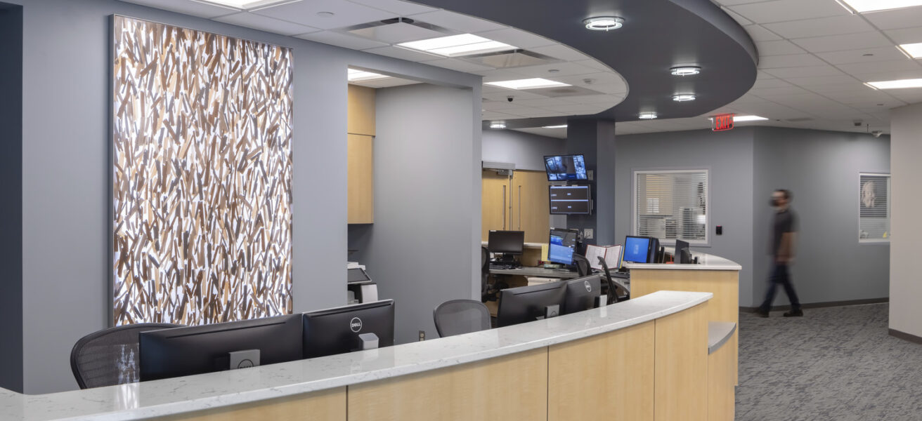 People talk at the reception desk in the Crete Area facility.