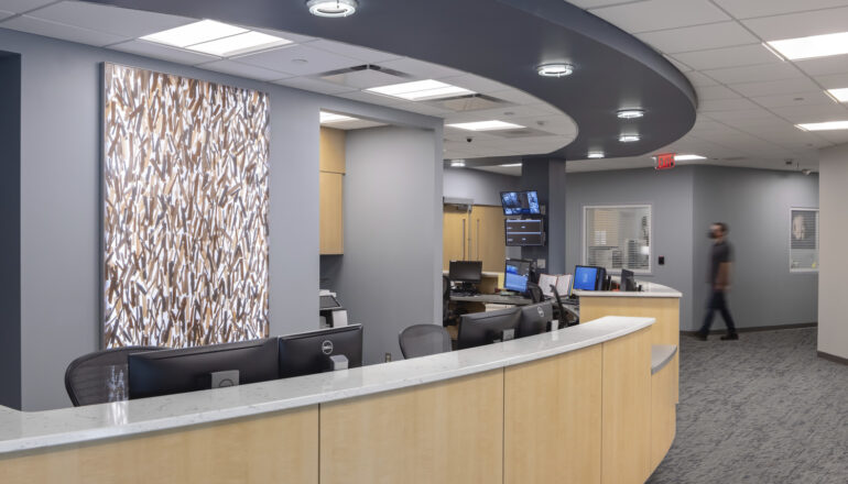 People talk at the reception desk in the Crete Area facility.