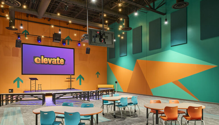 The Elevate classroom/worship space for grades 1-5 is brightly colored and filled with interactive games and technology.
