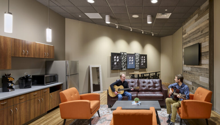 People practice guitar in the Eagle Brook Apple Valley green room.