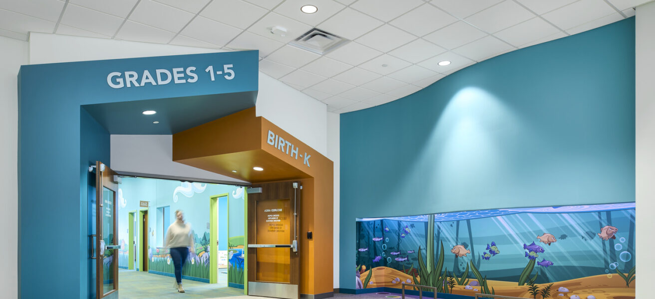 The secure entry to the Eagle Brook Apple Valley children's ministry wing is adjacent to a light up, color changing, fish-themed play area.