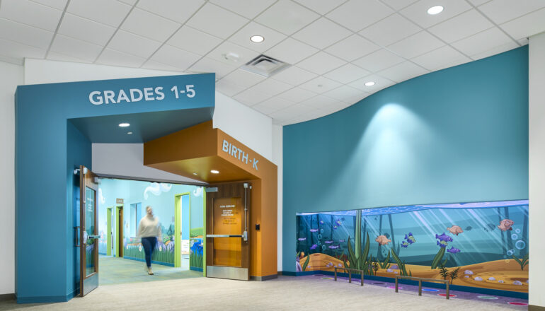The secure entry to the Eagle Brook Apple Valley children's ministry wing is adjacent to a light up, color changing, fish-themed play area.