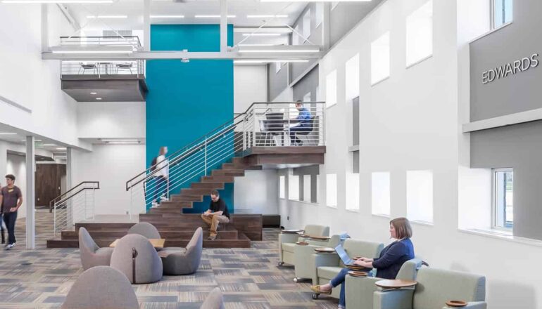 Students studying in an open atrium with access to study nooks.