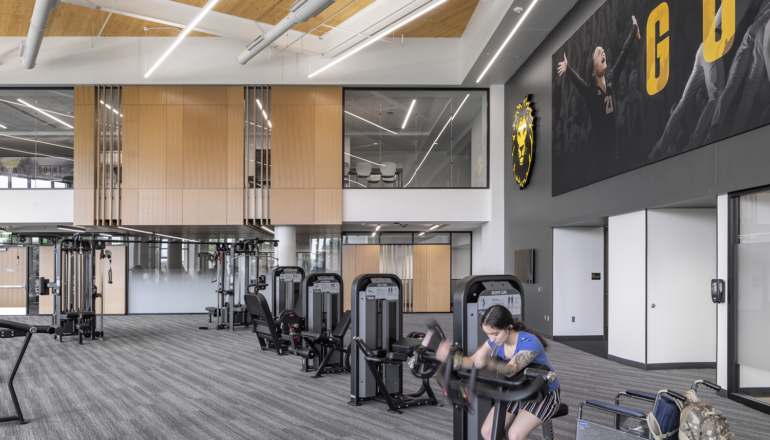 A person with a wheel chair works out in the welcoming Lund Center's cardio area