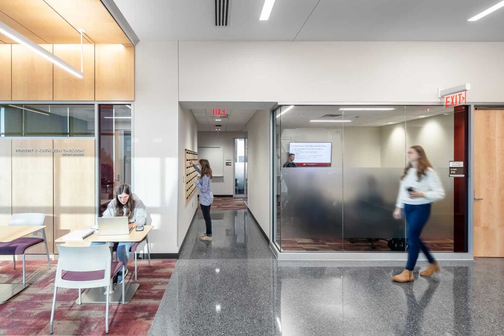 Students in corridor collaboration spaces outside of conference room.