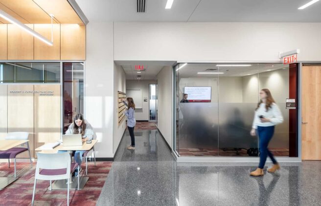 Students in corridor collaboration spaces outside of conference room.