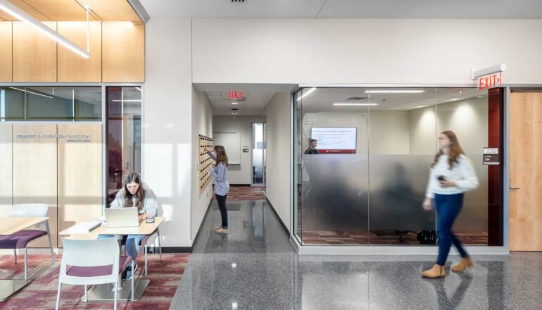 Students in corridor collaboration spaces outside of conference room.
