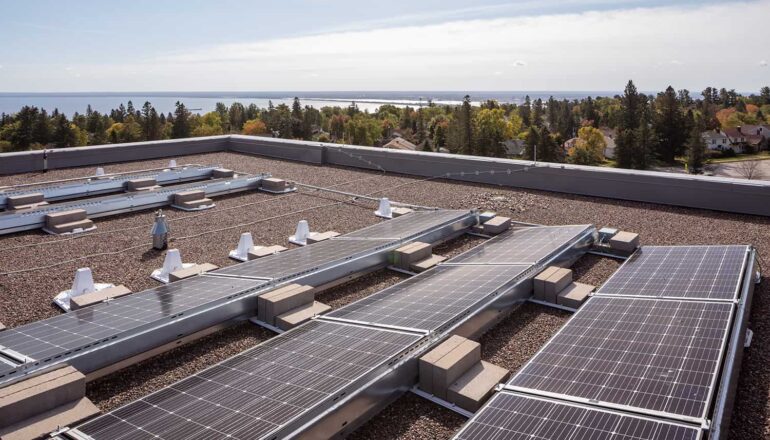 Rooftop solar panels and a view to Lake Superior.
