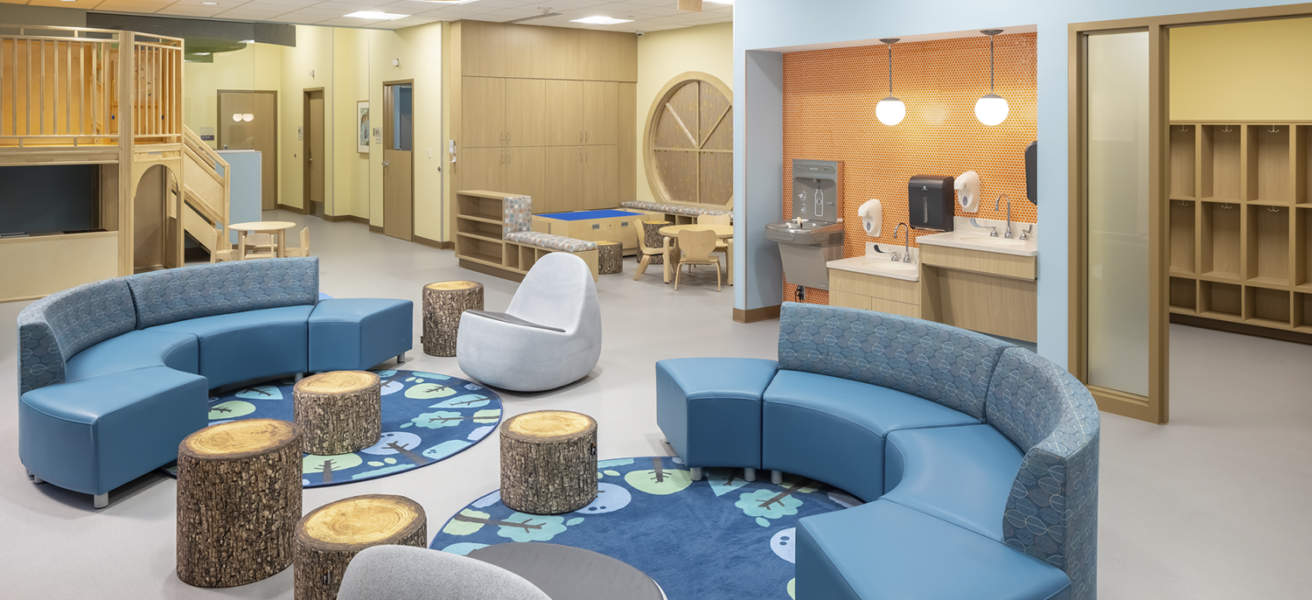The Redleaf Center's activity room is a balance of adult therapy spaces and children's play spaces. The entire family can receive care in one open area