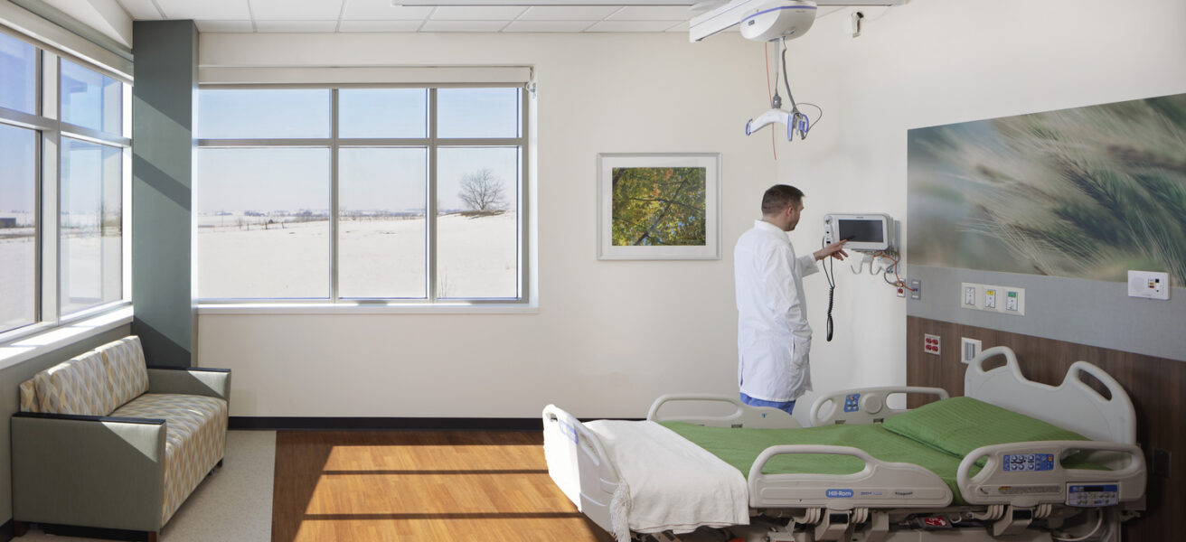 A doctor checks equipment in a hospice room in JCRHC.